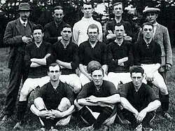 Players and staff pose for a photograph