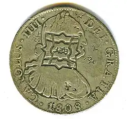 Anverso de moneda de 8 reales (plata) de Carlos IV de 1808 con resello de Zanzíbar.